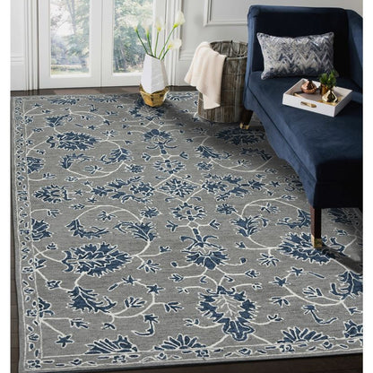Gray and blue patterned rug in a living room with a navy blue couch.