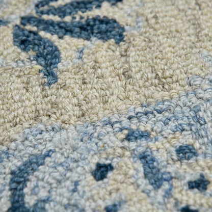 Close-up of a textured rug with blue and beige patterns