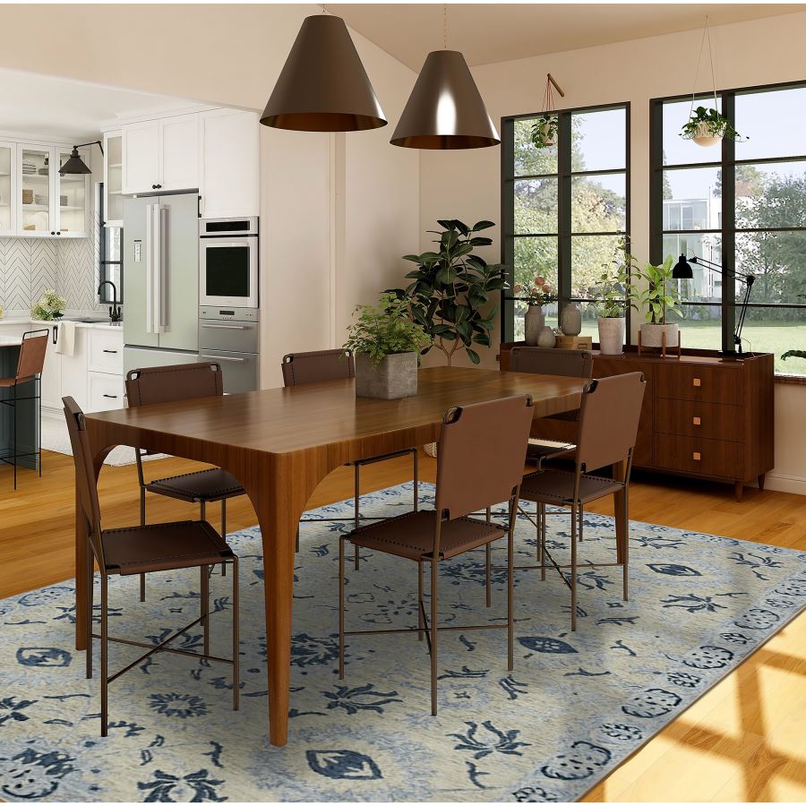 Dining room with wooden table and chairs on a patterned rug, large windows, and modern decor.