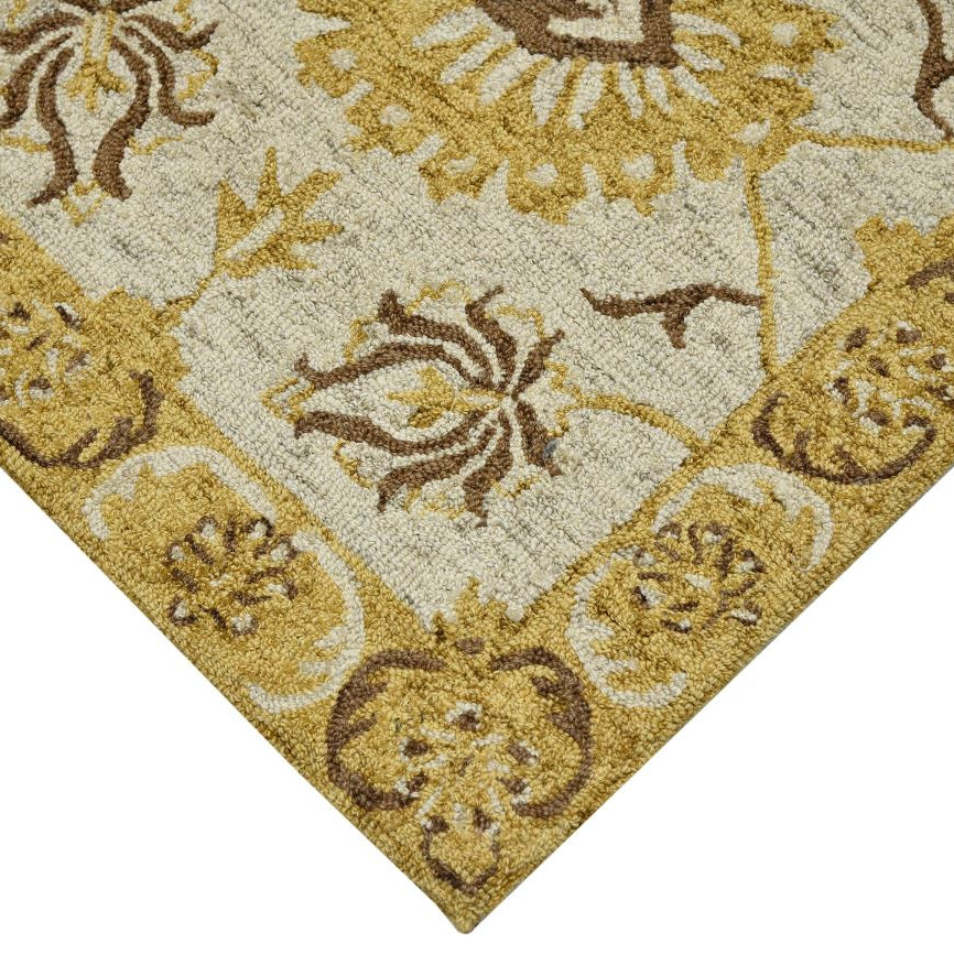 Close-up of a patterned rug with gold and brown colors.