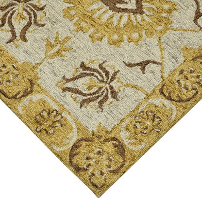 Close-up of a patterned rug with gold and brown colors.