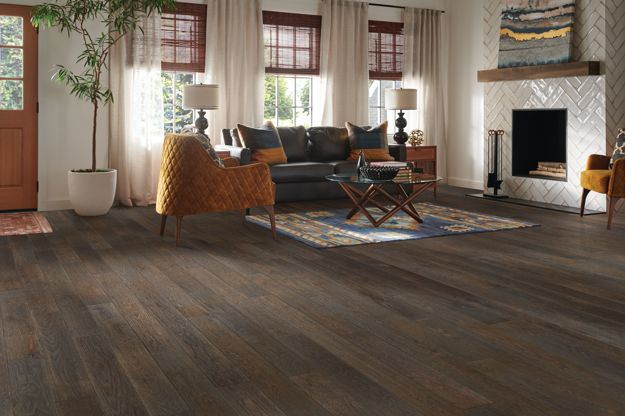 Living room with wooden flooring, furniture, and decor.