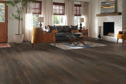 Living room with wooden flooring, furniture, and decor.