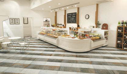 Modern bakery interior with a counter displaying various pastries and a wine rack.
