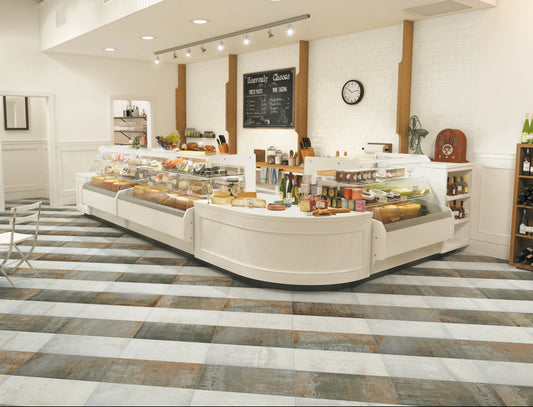 Modern bakery interior with a counter displaying various pastries and a wine rack.