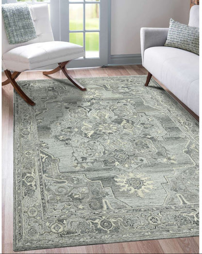 Patterned rug on a wooden floor with two white chairs and a glass door in the background.