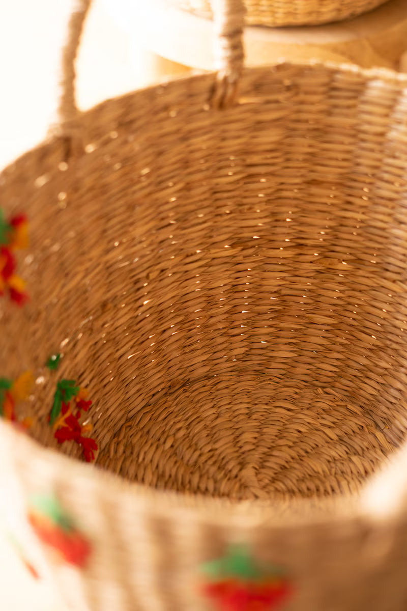Close-up of an woven basket with colorful patterns on a blurred background