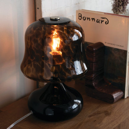 A black and brown tortoise glass table lamp