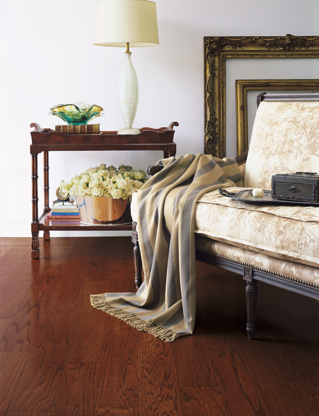 Decorative bedroom scene with a bed, side table, and lamp.