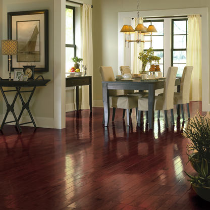Dining room with wooden floor, table, chairs, and decor.
