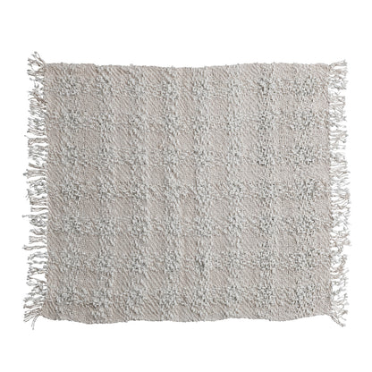 Textured gray pillow with fringes on a white background