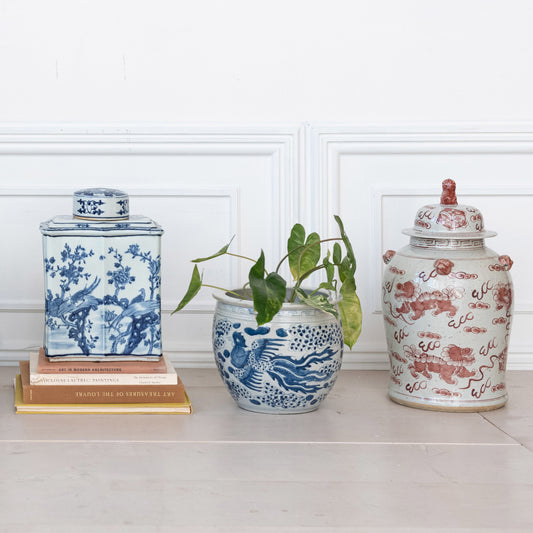 Three decorative vases with intricate designs on a white surface.