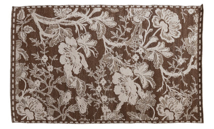 Floral patterned rug with brown background