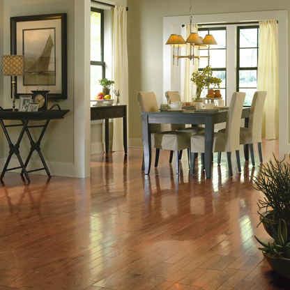 Dining room with wooden floor, table, chairs, and decor.