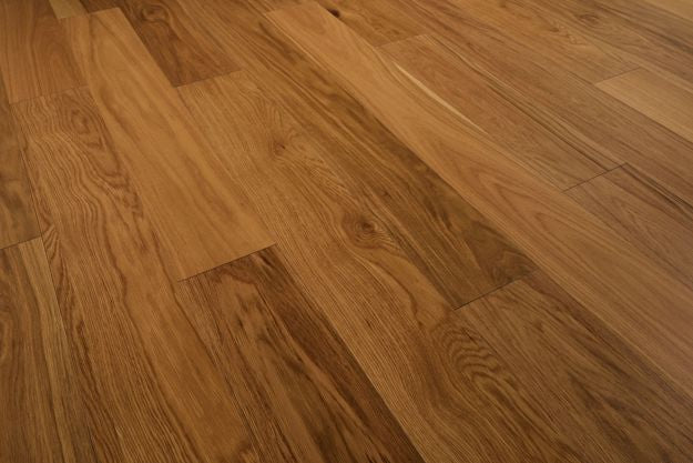 Close-up of a wooden floor with a warm brown color.