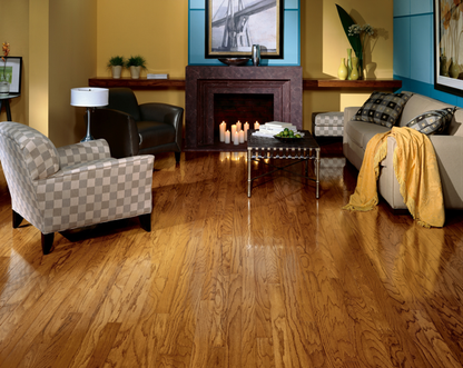Living room with wooden floor, furniture, and decorative items.