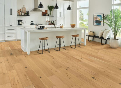 Modern kitchen with wooden flooring and white island.