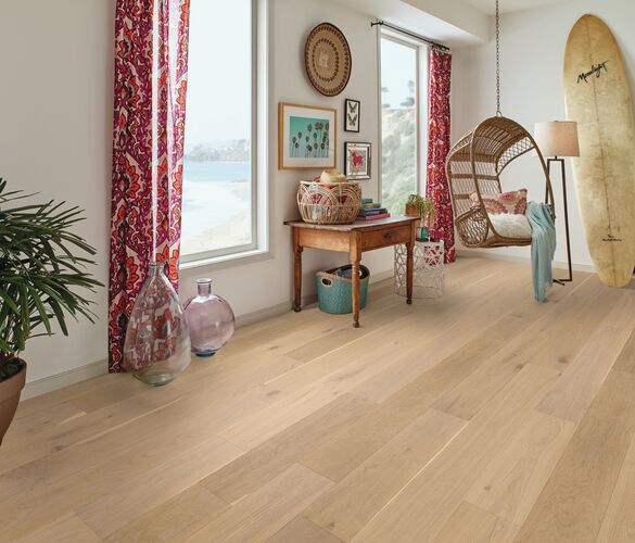 Living room with wooden flooring, a surfboard, and decorative items.