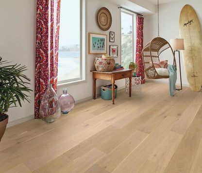 Living room with wooden flooring, a surfboard, and decorative items.