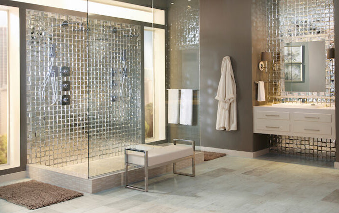 Modern bathroom with glass shower enclosure, sink, and decor