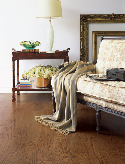 Decorative bedroom scene with a bed, side table, and lamp.